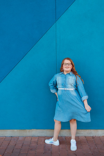 Zoey Banks standing against blue wall