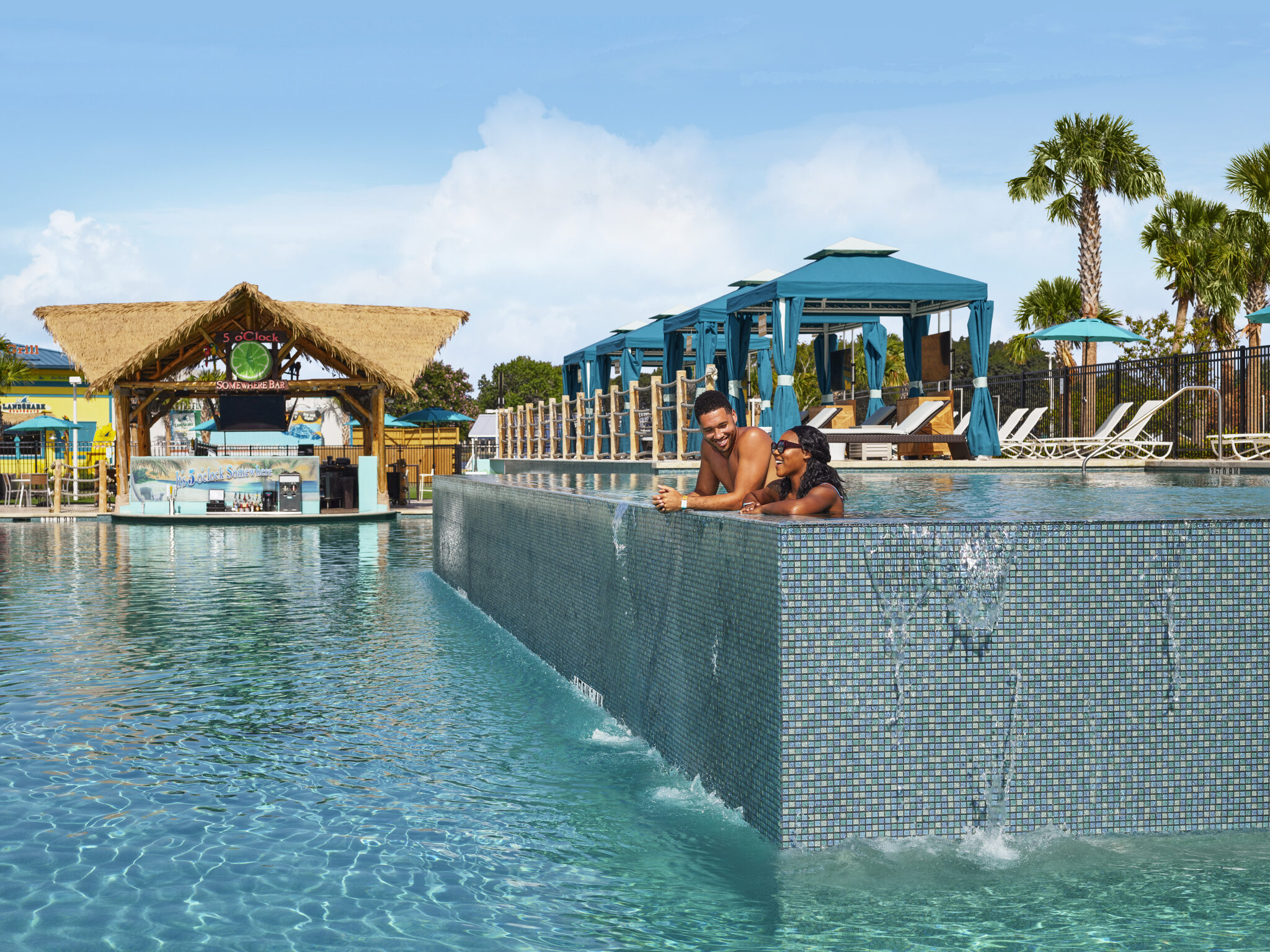 Two people swimming in the pool at Margaritaville Resort in Lake Conroe Texas