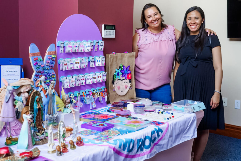 Two latinas at their vendor table